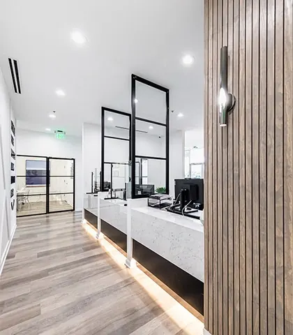 The corridor to the treatment rooms, with glass-panelled doors.